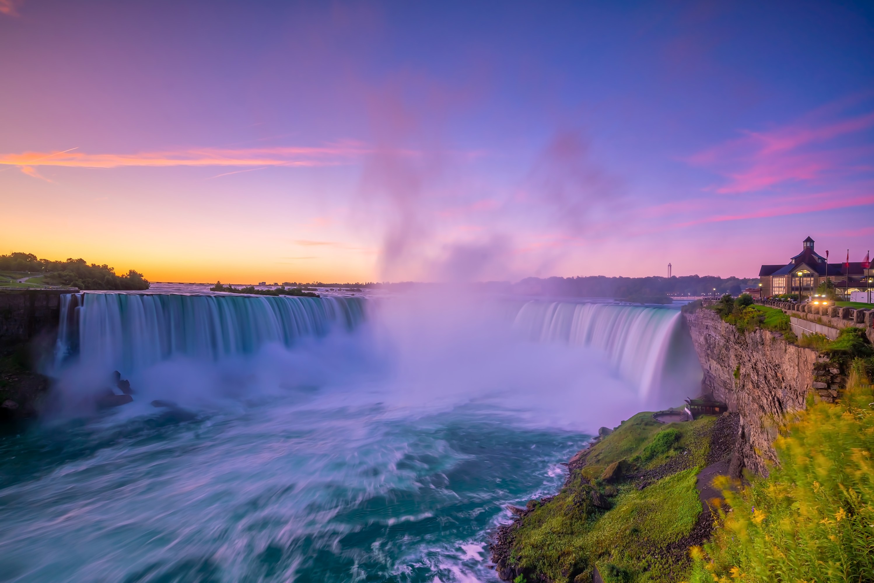 a large waterfall over a body of water