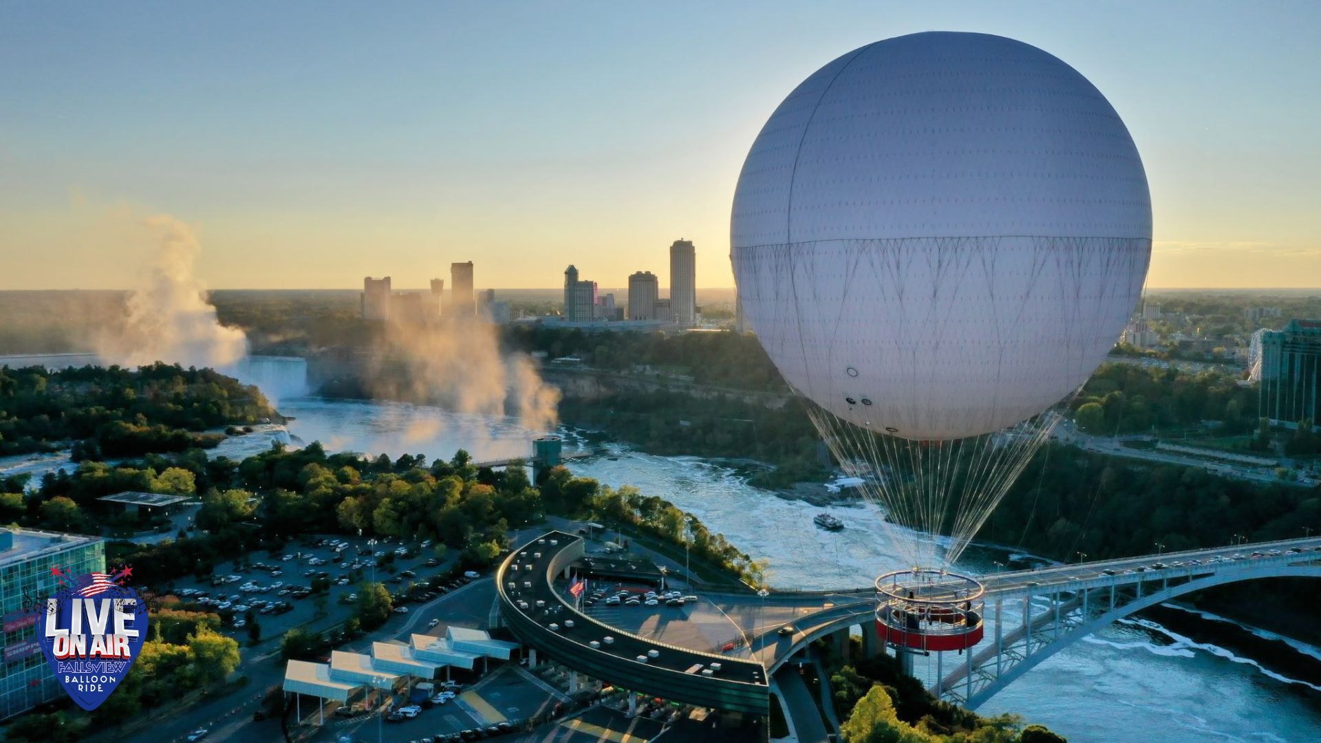 Large balloon over city skyline near a waterway and bridge at sunset.
