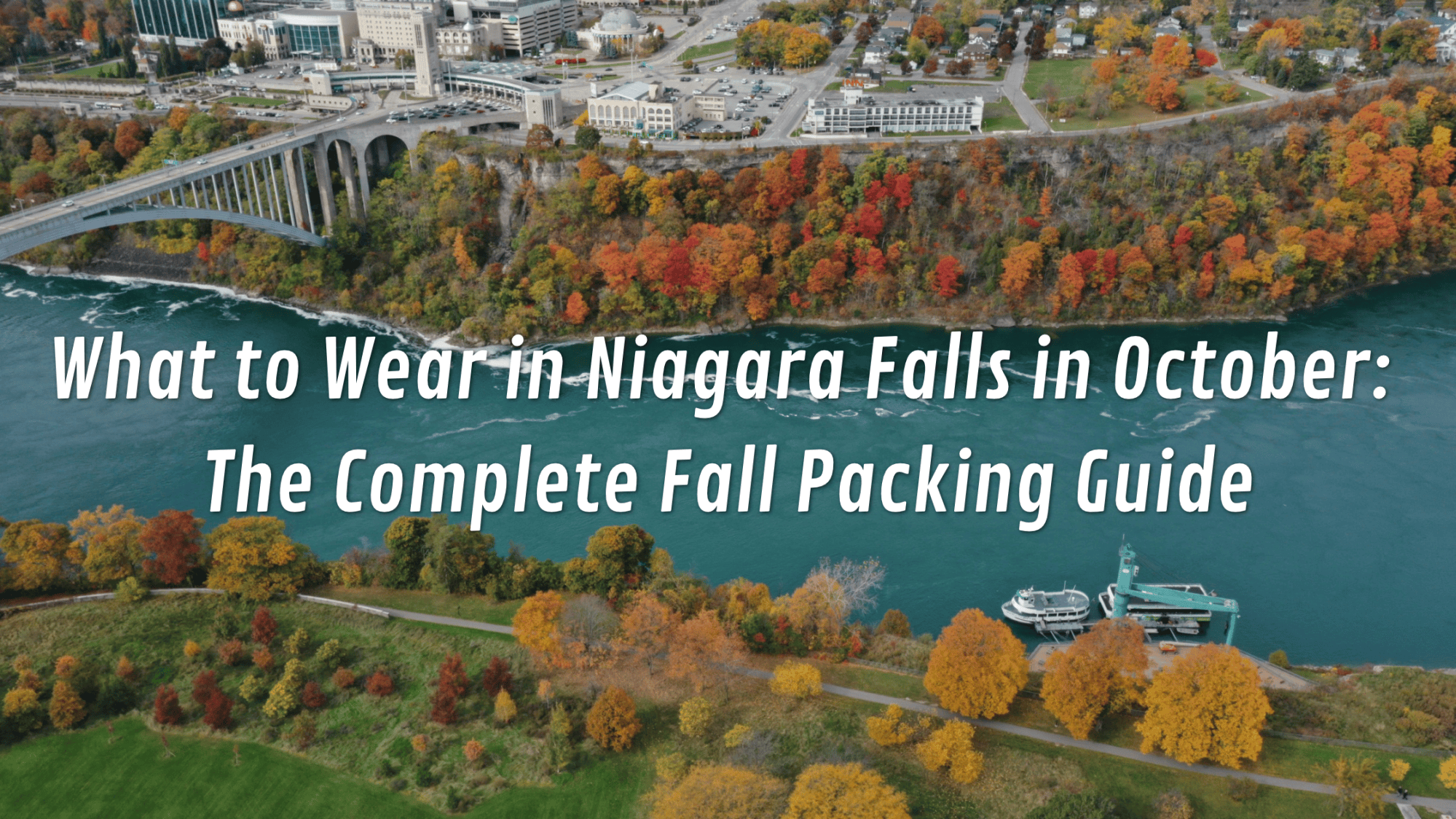 Aerial view of Niagara Falls with fall foliage and tour boat on the river.
